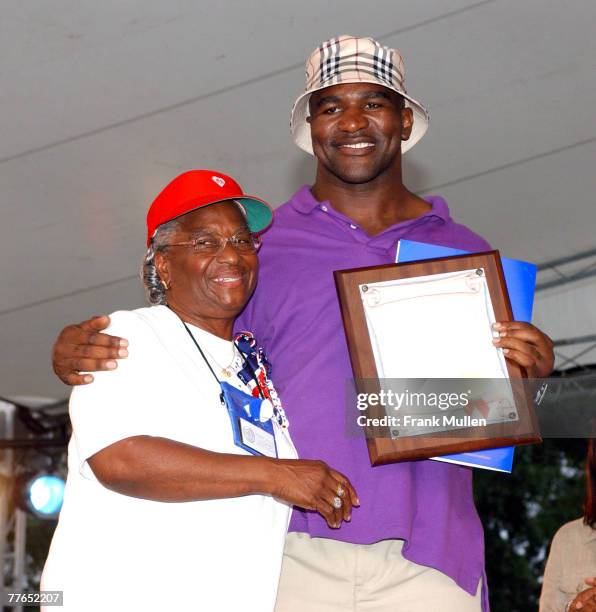 Evander Holyfield with Frankie Arnold of the City of Fairburn, GA, as she proclaims July 4, 2002 to be "Evander Holyfield Day" in Fairburn.