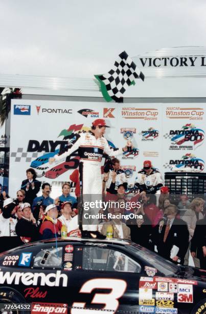 Legendary NASCAR driver Dale Earnhardt stands atop his Childress Racing Chevy and the racing world after winning the 1998 Daytona 500. The win ended...