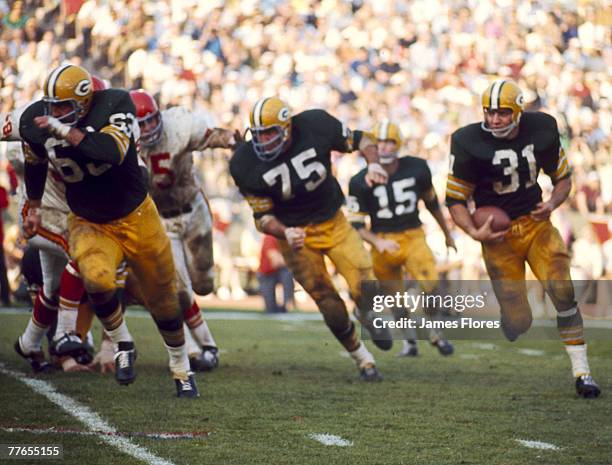 Green Bay Packers Hall of Fame running back Jim Taylor carries the ball in the famed "Green Bay sweep" against the Kansas City Chiefs in the Packers'...