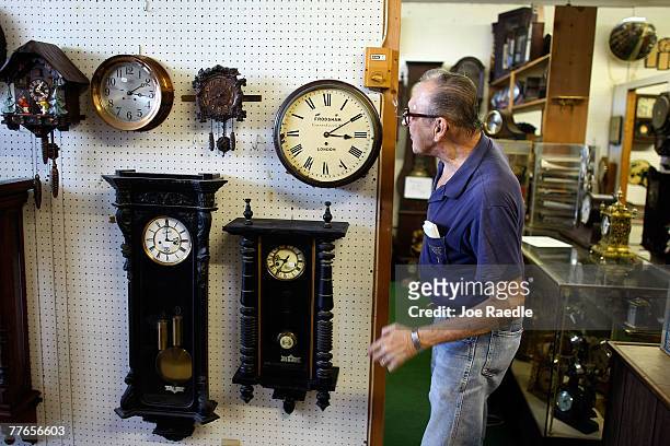 Howie Brown checks clocks in his clock shop as he adjusts the time back one hour for the end of day light savings time at Brown's Old Time Clock Shop...