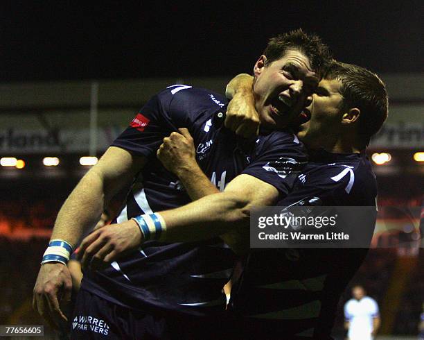 Steve Hanley and Richard Wiggleworth of Sale Sharks celebrates their team mate Chris Bell's try during the EDF Energy Cup match between Sale Sharks...