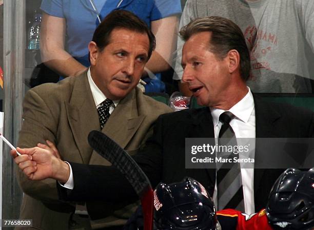 Head coach Jaques Martin of the Florida Panthers listens to assistant coach Mike Kitchen behind the bench against the Philadelphia Flyers on October...