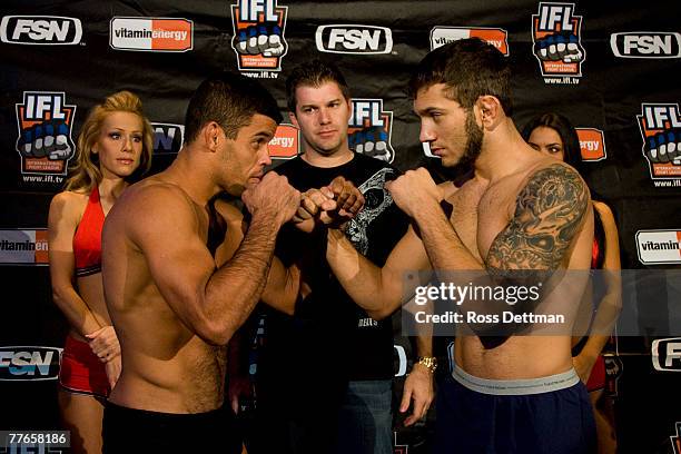 Wagnney Fabiano of the Dragons poses with John Gunderson of the Lions during the weigh-in for the IFL World Grand Prix at the Buffalo Wild Wings...