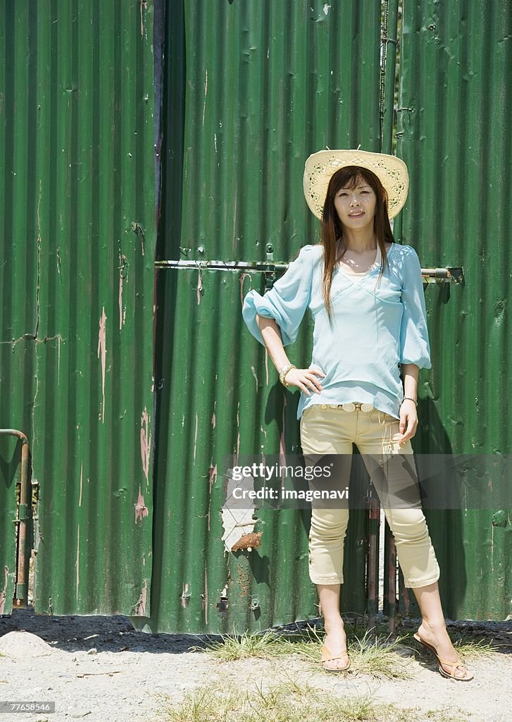 Woman standing before wall