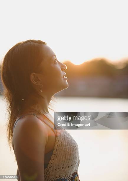 woman looking up sky - キャミソール ストックフォトと画像