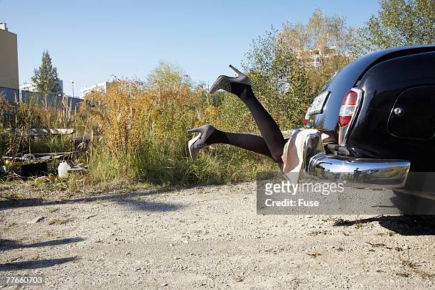 woman's legs sticking out of a trunk - snatch stock pictures, royalty-free photos & images