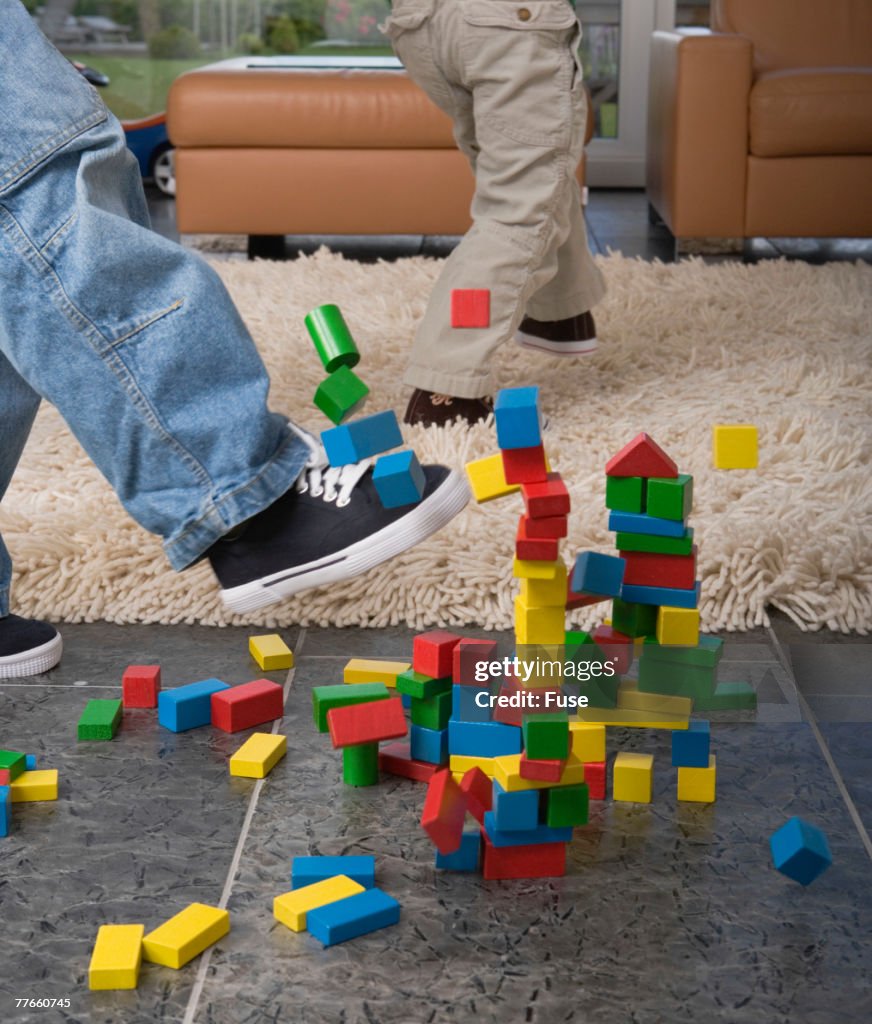 Boy Deleting House of Building Blocks