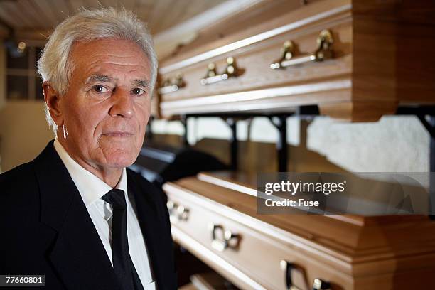 man standing in funeral parlor - leichenbestatter stock-fotos und bilder
