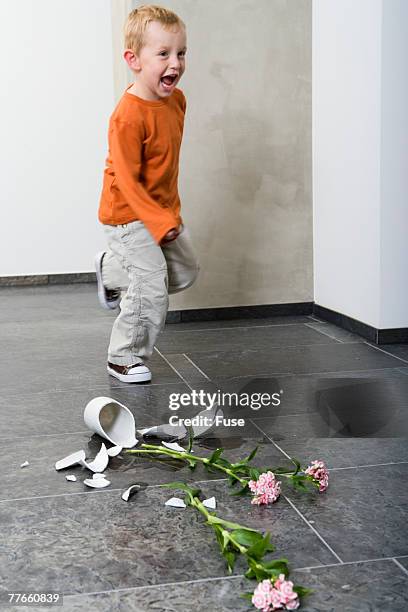 boy with broken vase - broken vase stock pictures, royalty-free photos & images