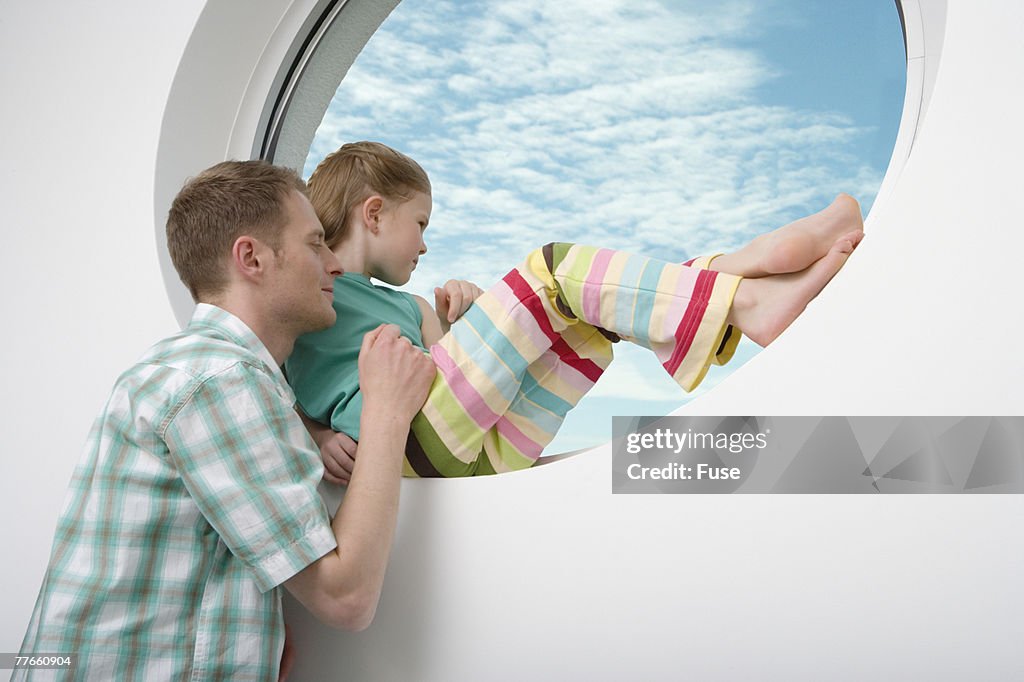 Father and Daughter Looking out of Window