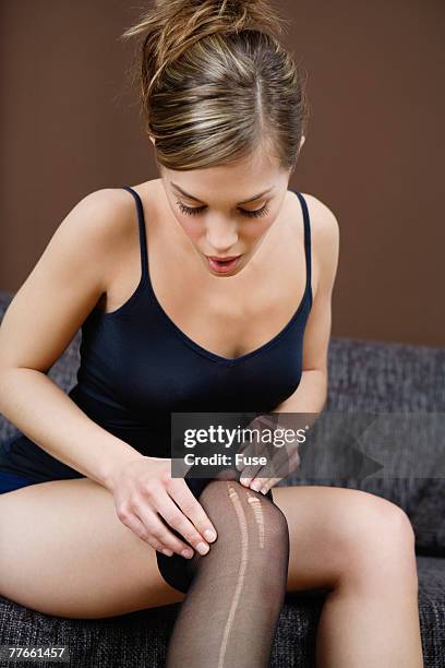 woman discovering tear in panty hose - damstrumpor bildbanksfoton och bilder