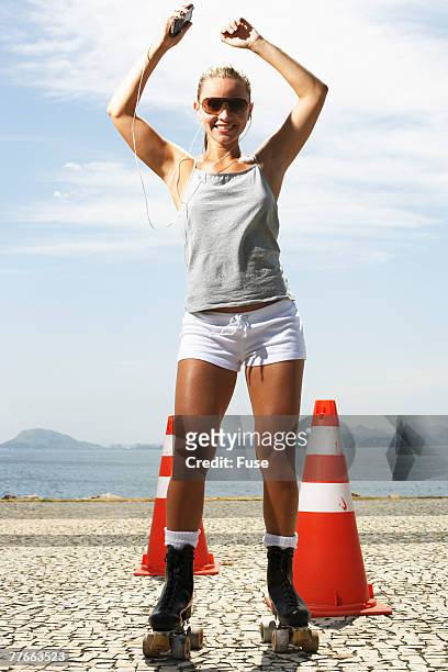 young woman roller skating - elektro roller stockfoto's en -beelden