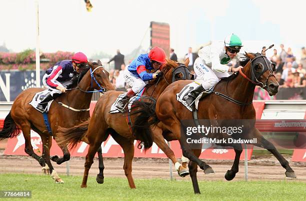 Peter Mertens riding Sirmione goes to the lead in the Mackinnon Stakes during the AAMI Victoria Derby Day held at Flemington Race Course November 3,...