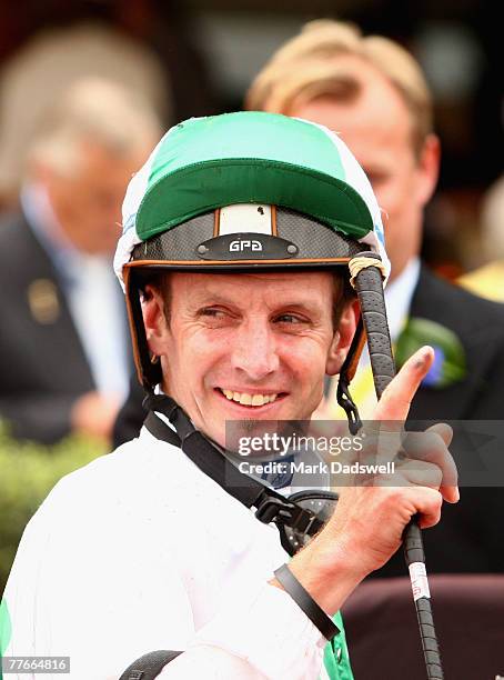 Peter Mertens celebrates after riding Sirmione to win the Mackinnon Stakes during the AAMI Victoria Derby Day held at Flemington Race Course November...