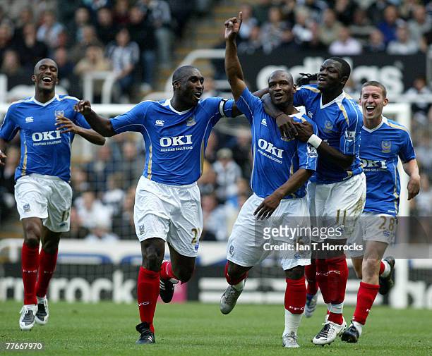 Noe Pamarot of Portsmouth celebrates with teammate Sulley Muntari and Sol Campbell after scoring his teams first goal during the Barclays Premier...