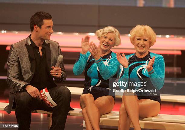 Tv host Marco Schreyl chats with contestants Renate Recknagel and Roswitha Wahl during the live-broadcast of his tv show "Das Supertalent" November...