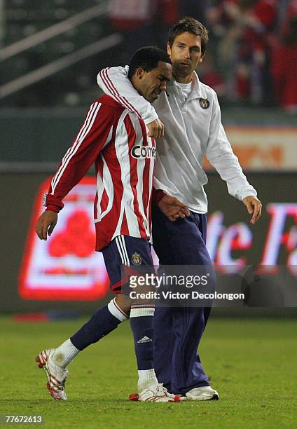 Injured CD Chivas USA player Ante Razov consoles teammate Maykel Galindo after their Western Conference playoff 0-0 game against the Kansas City...