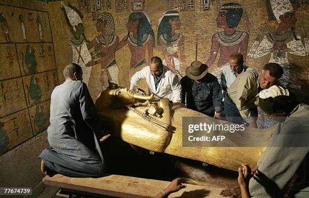 Egypt's antiquities chief Zahi Hawass supervises the removal of the lid of the sarcophagus of King Tutankhamun in his underground tomb in the famed...