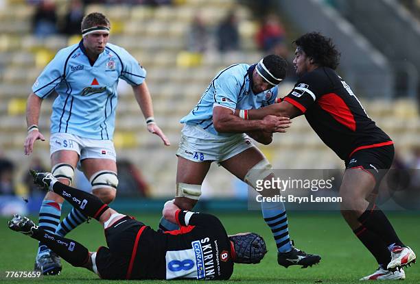 Andrew Blowers of Bristol is tackled by Ben Skirving and Cencus Johnston of Saracens during the EDF Energy Cup match between Saracens and Bristol at...