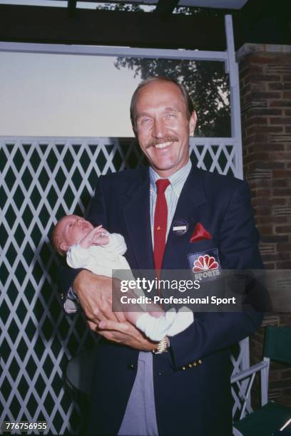 American tennis player Stan Smith holds his baby daughter during the Wimbledon Lawn Tennis Championships at the All England Lawn Tennis Club in...