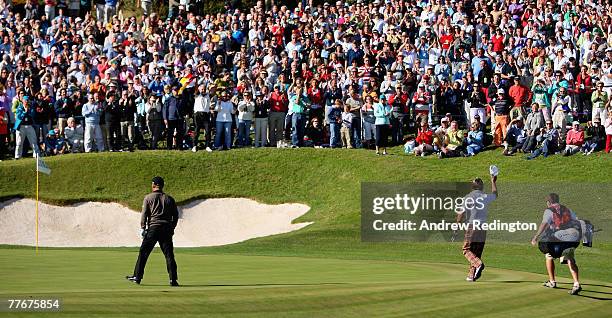 Graeme McDowell of Northern Ireland takes the applause from spectators after holing his second shot for an albatross on the par 5 17th hole during...