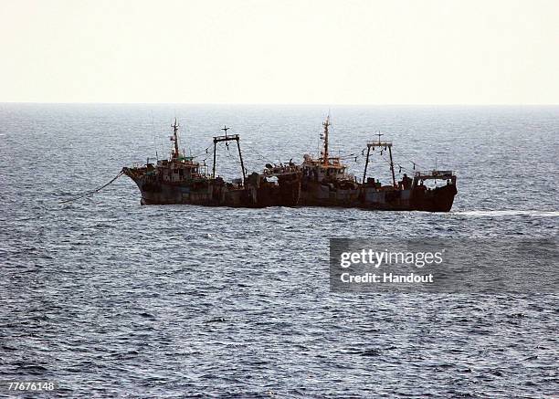 In this photo provided by the U.S. Navy, Tanzanian-flagged fishing trawlers Mavuno I and Mavuno II rendezvous with a U.S. Navy ship after being...