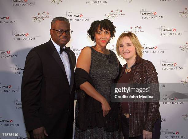 Safeway Senior VP James White and wife Lisa pose for a photo with Melissa Etheridge during the Safeway Foundation Gala 'Nuture the Seeds of Hope' on...