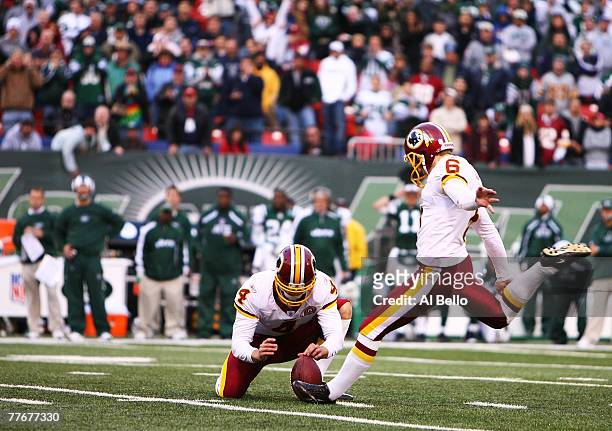 Shaun Suisham of the Washington Redskins kicks the winning field goal in overtime against the New York Jets to win 23-20 on November 4, 2007 at...
