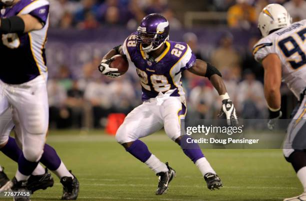 Adrian Peterson of the Minnesota Vikings rushes against the San Diego Chargers at the Hubert H. Humphrey Metrodome on November 4, 2007 in...