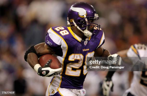 Adrian Peterson of the Minnesota Vikings rushes against the San Diego Chargers at the Hubert H. Humphrey Metrodome on November 4, 2007 in...