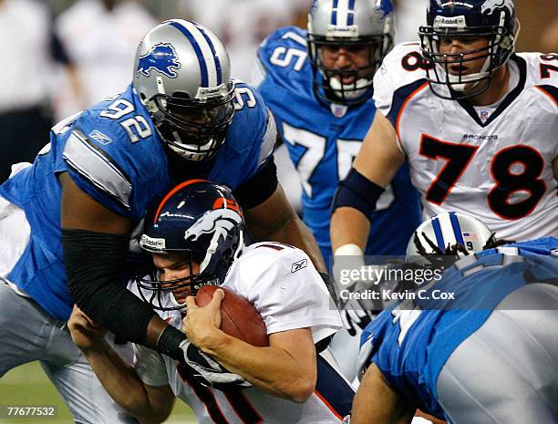 Quarterback Patrick Ramsey of the Denver Broncos collides with defensive tackle Shaun Rogers of the Detroit Lions during the second half at Ford...