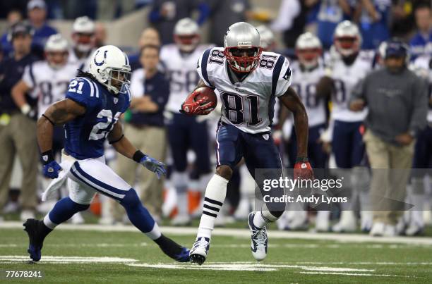 Randy Moss of the New England Patriots runs for yards after the catch against Bob Sanders of the Indianapolis Colts on November 4, 2007 at the RCA...