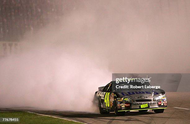 Jimmie Johnson, driver of the Lowe's/Kobalt Chevrolet, does a burnout after winning the NASCAR Nextel Cup Series Dickies 500 at Texas Motor Speedway...