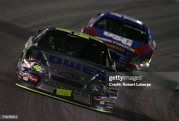Jimmie Johnson, driver of the Lowe's/Kobalt Chevrolet, leads Matt Kenseth, driver of the USG Ford, during the NASCAR Nextel Cup Series Dickies 500 at...