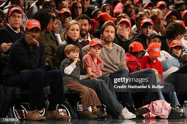 Actor/comedian Chris Rock, actress Tea Leoni and her husband actor David Duchovny and their children attend the Minnesota Timberwolves game against...