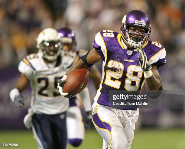 Adrian Peterson of the Minnesota Vikings carries the ball during an NFL game against the San Diego Chargers at the Hubert H. Humphrey Metrodome,...