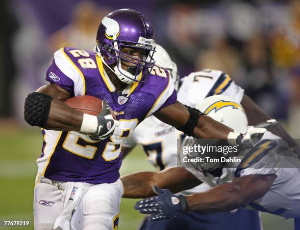 Adrian Peterson of the Minnesota Vikings carries the ball during an NFL game against the San Diego Chargers at the Hubert H. Humphrey Metrodome,...