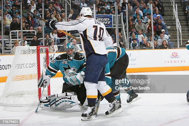 Martin Erat of the Nashville Predators takes his shot on net against Evgeni Nabokov and Matt Carle of the San Jose Sharks during an NHL game on...