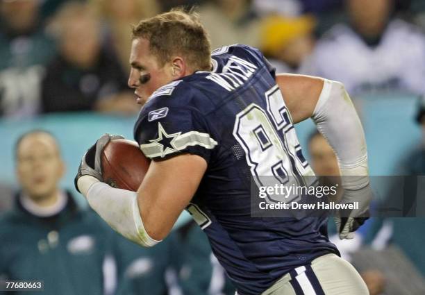 Tight end Jason Witten of the Dallas Cowboys runs with the ball after losing his helmet during the game against the Philadelphia Eagles at Lincoln...