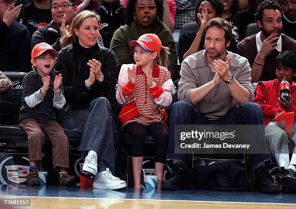 A Leoni and David Duchovny with their children attend Minnesota Timberwolves vs NY Knicks basketball game at Madison Square Garden in New York City...