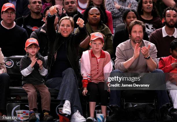 A Leoni and David Duchovny with their children attend Minnesota Timberwolves vs NY Knicks basketball game at Madison Square Garden in New York City...