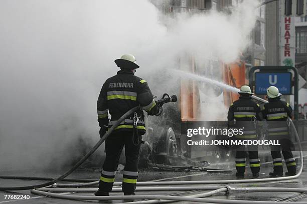 German firefighters douse a garbage dumpster that caught fire on Berlin's main Friedrichstrasse thoroughfare 05 November 2007. The cause of the...