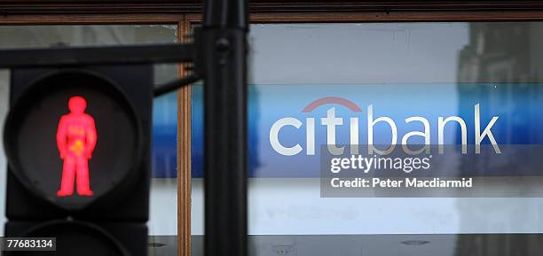 Pedestrian crossing sign is illuminated red in front of a branch of Citibank at The Strand on November 5, 2007 in central London. Chairman and chief...