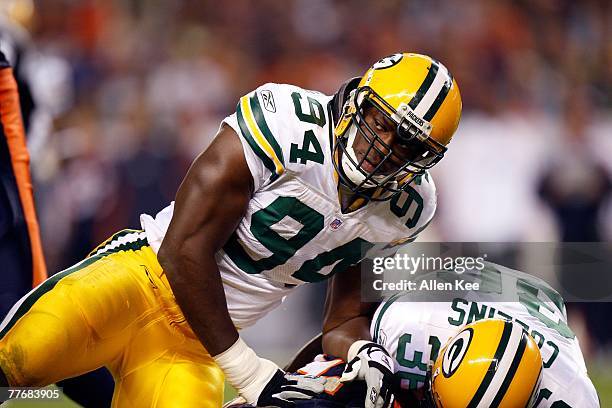 Defensive end Kabeer Gbaja-Biamila of the Green Bay Packers moves to tackle the Denver Broncos at Invesco Field at Mile High on September 23, 2007 in...