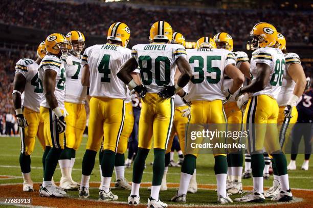 Quarterback Brett Favre of the Green Bay Packers talks to his offense in a huddle during the game against the Denver Broncos defense at Invesco Field...