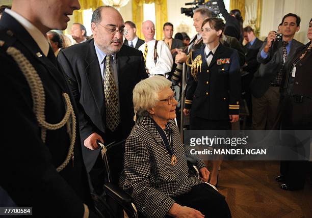 "To Kill A Mockingbird" novelist Harper Lee is helped from the East Room after receiving the 2007 Presidential Medal of Freedom 05 November 2007 at...