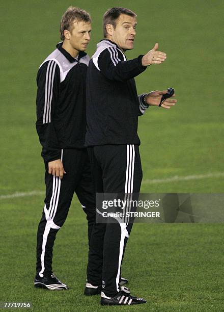 Rosenborg's coach Trond Henriksen speaks with Slovenian player Marek Sapara during a training session at Mestalla Stadium in Valencia 05 November...