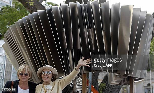 Two women pose in front of the first monument dedicated to Tango in the world 05 November, 2007 in Buenos Aires. The 2-ton and 5-metre-tall metallic...