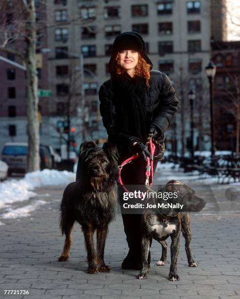 Bernadette Peters stands with her dogs during the winter of 1995 on the street in New York City. Peters, an award winning singer and actress has...