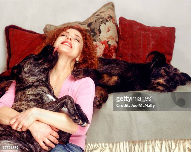Bernadette Peters poses with her dogs during the winter of 1995 at her apartment in New York City. Peters, an award winning singer and actress has...